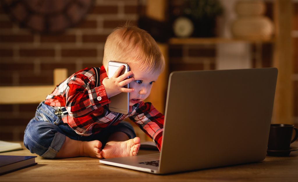 baby pretending to be on phone and computer