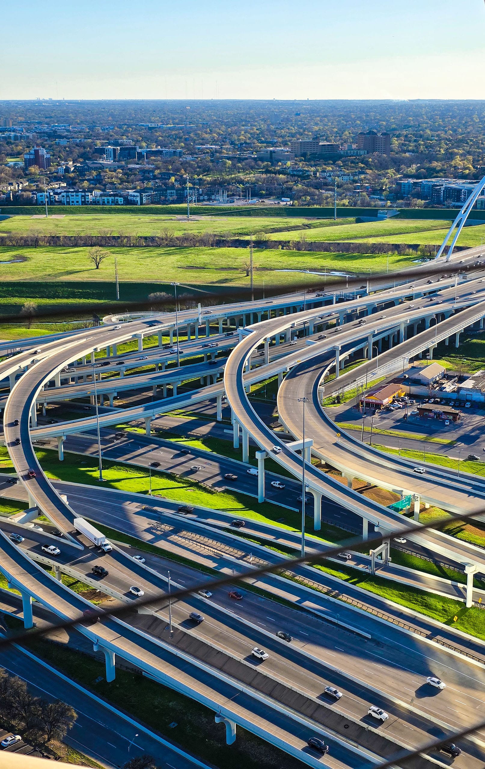 Aerial view of highway interchange and skyline near Frisco Plano, Texas, part of the Dallas Fort Worth families served by nanny placement services