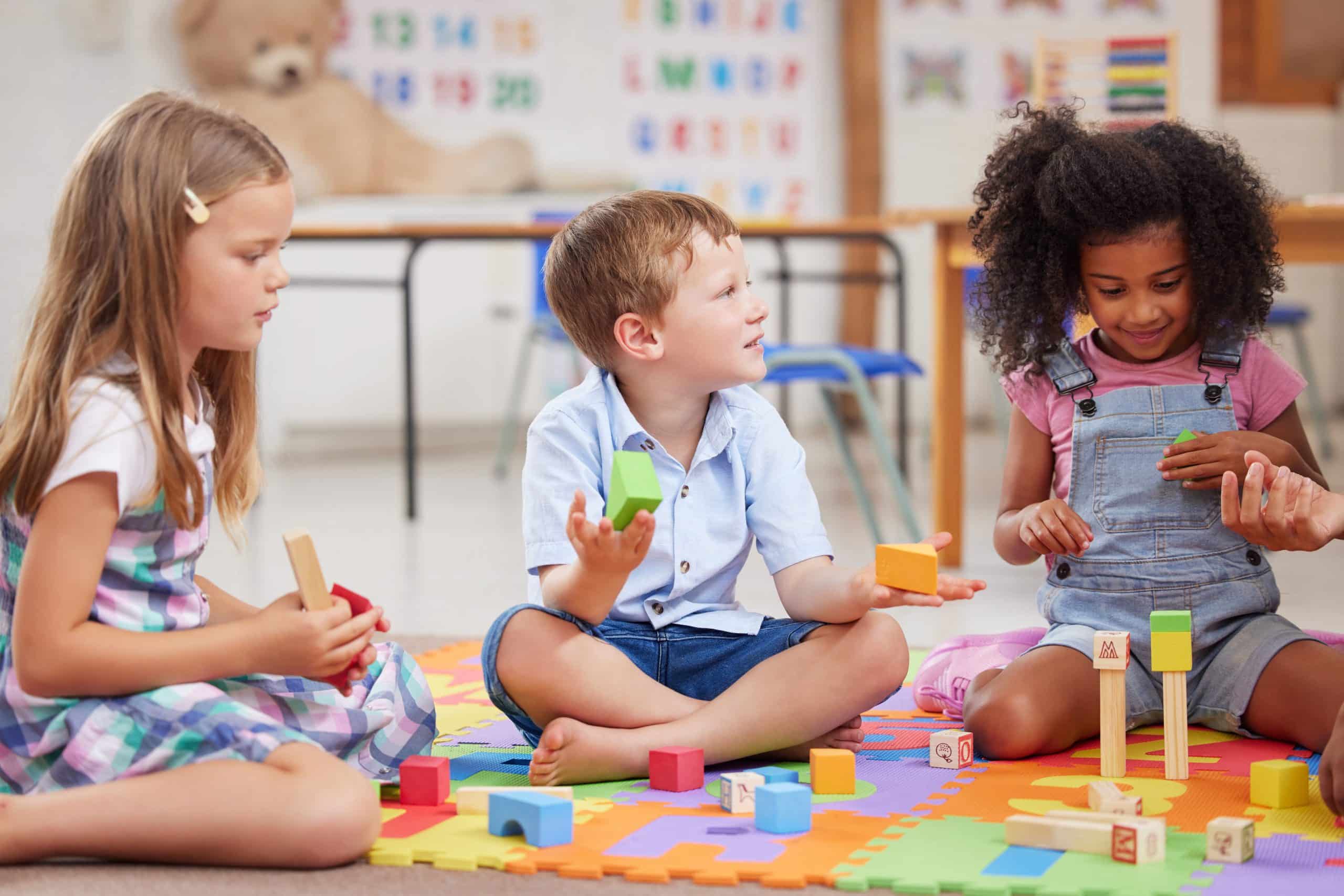 Kids playing with blocks in a classroom, building trust with outside church caregivers