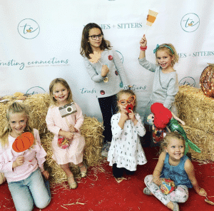 Happy children holding autumn themed photo booth props at a Trusting Connections family gathering Happy children holding autumn themed photo booth props at a Trusting Connections family gathering